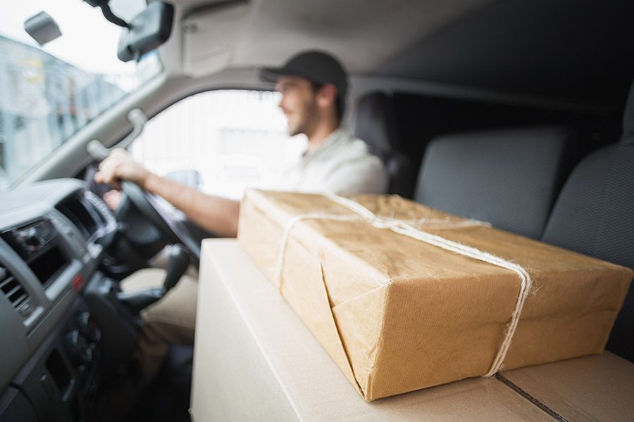 Amazon DSP Insurance - Delivery Driver Driving Van With Parcels on Seat